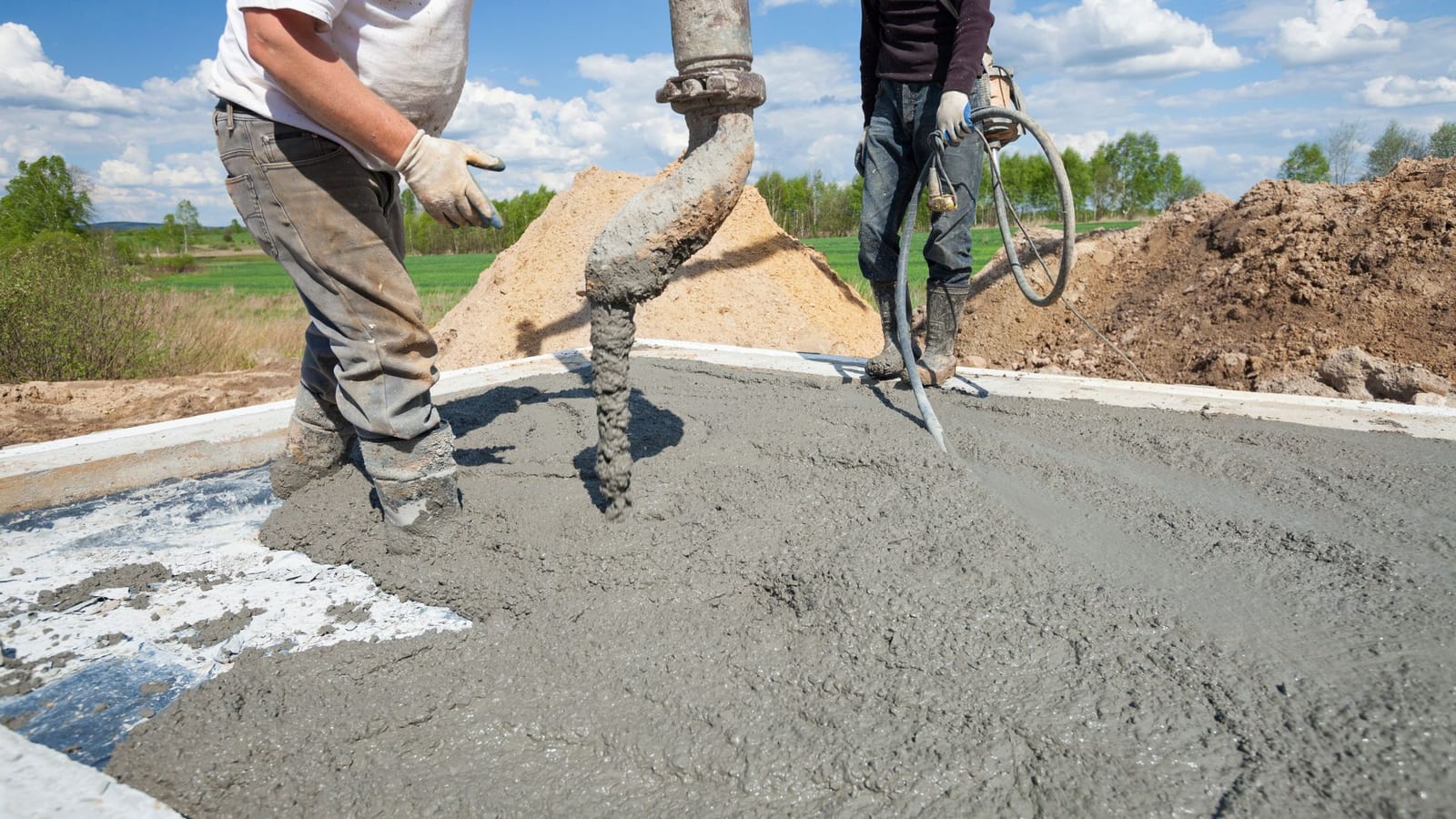 Deux ouvriers en plein coulage d'une dalle béton 20 m²